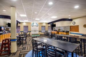 a dining area with tables and chairs in a restaurant at SureStay Hotel by Best Western Bardstown General Nelson in Bardstown