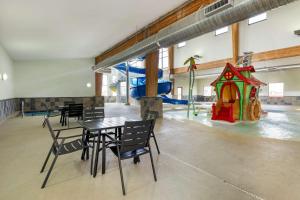 a dining room with a table and a playground at Best Western Watertown Inn & Suites in Watertown