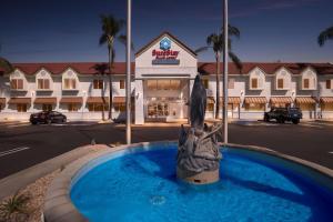 a statue in a fountain in front of a hotel at SureStay Plus Hotel by Best Western Upland - Ontario North in Upland