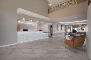 a lobby with a reception desk and a waiting room at SureStay Plus Hotel by Best Western Upland - Ontario North in Upland +24 photos