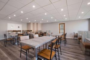 a dining room with tables and chairs in it at SureStay Plus Hotel by Best Western Upland - Ontario North in Upland