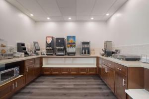 a large kitchen with wooden cabinets and appliances at SureStay Plus Hotel by Best Western Upland - Ontario North in Upland