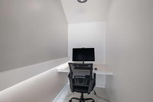 a computer sitting on a desk with a chair at SureStay Plus Hotel by Best Western Upland - Ontario North in Upland