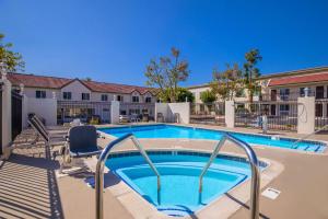 a large swimming pool with a chair at SureStay Plus Hotel by Best Western Upland - Ontario North in Upland