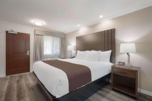 a hotel room with a large bed and a window at SureStay Plus Hotel by Best Western Upland - Ontario North in Upland