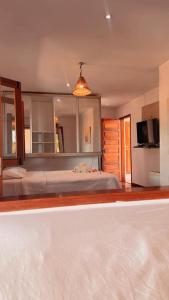 a bedroom with a bed and a television in it at Vila Moana Jeri in Jericoacoara