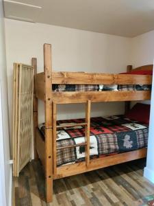 two wooden bunk beds in a room at Alex's Cozy STUDIO with Pool and Sauna in Brian Head