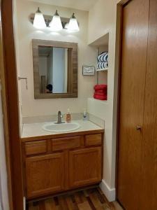a bathroom with a sink and a mirror at Alex's Cozy STUDIO with Pool and Sauna in Brian Head