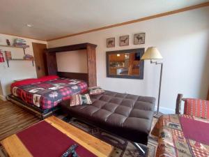 a living room with a couch and a bed at Alex's Cozy STUDIO with Pool and Sauna in Brian Head