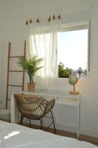 a bedroom with a desk and a chair and a window at Rosamar 211 Los Cristianos Ocean Views in Arona