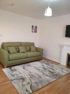 a living room with a couch and a rug at Lovely 2-Bedroom Condo With indoor Fire Place in London