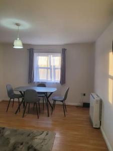 a dining room with a table and chairs and a window at Lovely 2-Bedroom Condo With indoor Fire Place in London