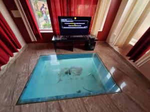 a room with a glass table with a flower on the floor at Le Grace Beachview in Chennai