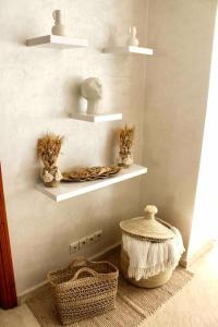 a room with shelves and baskets on a wall at Cosy appartement au cœur de Gueliz in Marrakesh