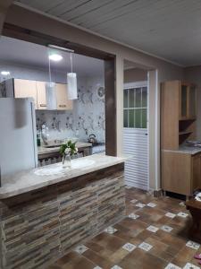 a kitchen with a counter and a refrigerator in it at Madreselva in Xuí