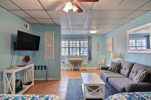a living room with a couch and a tv at On the Half Shell in Port Aransas