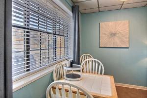a dining room with a table and chairs and a window at On the Half Shell in Port Aransas