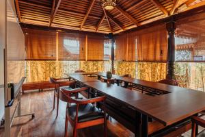 a conference room with wooden tables and chairs at Yushili Hotel Kampala in Kampala