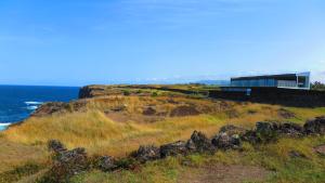 a building on a hill next to the ocean at Sao Vicente Lodge - Atlantic Retreat in São Vicente Ferreira