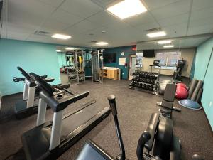a gym with treadmills and machines in a room at AVID Hotels - Fort Wayne North, an IHG Hotel in Fort Wayne
