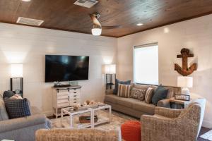 a living room with a couch and a tv at Getaway in Port Aransas