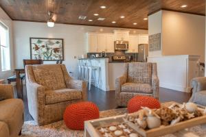 a living room with two chairs and a kitchen at Getaway in Port Aransas