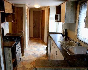 a kitchen with a sink and a counter top at Devon Cliffs Holiday Park - Haven, 3 Bed - ABI Horizon - Wi Fi in Exmouth