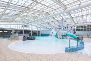 a large indoor swimming pool with a water park at Devon Cliffs Holiday Park - Haven, 3 Bed - ABI Horizon - Wi Fi in Exmouth