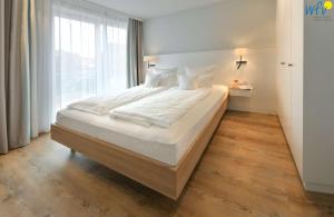 Postel nebo postele na pokoji v ubytování Toewerhus - Wohnung Muschel
