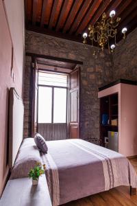 a bedroom with a large bed and a window at Hotel Cantera Rosa in Morelia