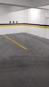 an empty parking lot with a yellow stripe on the side of an airplane at APARTAMENTO NOVO E COMPLETO in Piratuba