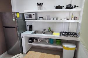 a small kitchen with a sink and a refrigerator at Cafe Departament 33 M2 NEW CIVAC ,Walmart Y NISSAN in Jiutepec