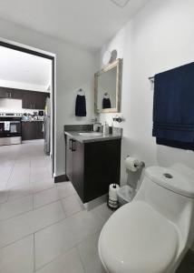a white bathroom with a toilet and a sink at Avitat Joy Finest 1Brm Studio Great View Pool&Gym in San Salvador