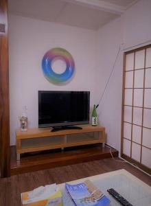 a living room with a flat screen tv on a table at 湘南の潮風に吹かれて自然豊かな丘ーーー湘南の丘のヴィラ＠ふじさわ in Fujisawa