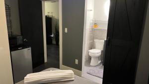 a bathroom with a white toilet and a sink at HEART OF WILTON MANORS in Fort Lauderdale