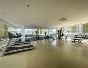 a gym with cardio equipment in a large building at SoSe's Crib at Mesaverte Garden Residences in Cagayan de Oro