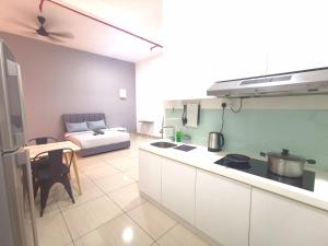 a kitchen and living room with a bed in the background at Austin Manhattan 1BR Johor Bahru by Maco Home in Johor Bahru