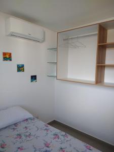 a bedroom with a bed and a medicine cabinet at Flat- maraca bech residence 2 in Ipojuca