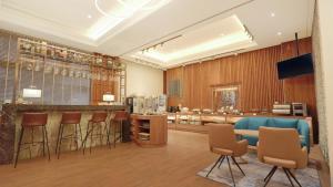 a lobby with a bar with stools and a counter at Hej Taipei Arena Hotel in Taipei