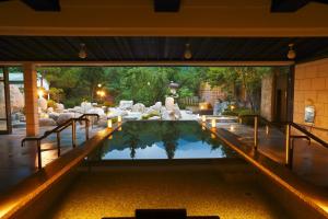 a pool in the middle of a house with lights at TAOYA Kisoji in Nagiso
