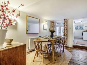 a dining room with a table and chairs at The Yellow Cottage On The Hill in Framlingham