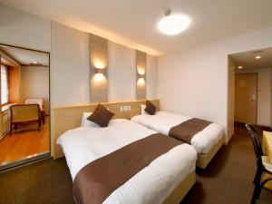 Posteľ alebo postele v izbe v ubytovaní Hotel Palm Spring