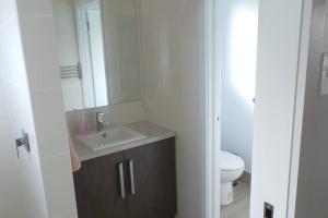 a bathroom with a sink and a toilet at Southern Comfort in Goolwa North