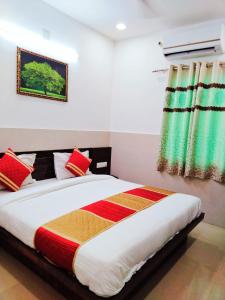 a bedroom with a large bed with colorful pillows at Homestayinn in Ahmedabad