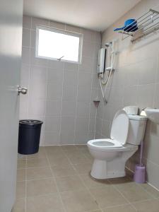 a bathroom with a toilet and a phone on the wall at Dlake Putrajaya Homestay in Putrajaya