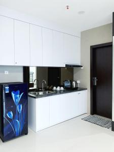 a kitchen with white cabinets and a blue flower painted on the counter at FORMOSA RESIDENCEN - The Apartments 2 Bed Room in Nagoya +12 photos