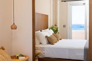 a bedroom with a bed with two teddy bears on it at Almi of Naxos in Naxos Chora