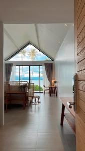 a large living room with a view of the ocean at Little Moon Villa in Ko Mak