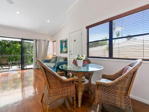 a living room with a table and chairs and a couch at Unit 3 Kookaburra Lodge 8 Little Cove Road Little Cove in Noosa Heads