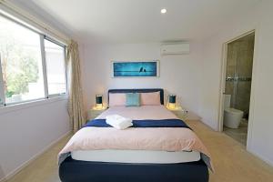 a bedroom with a large bed and a window at Melbourne Luxury Villa at Doncaster in Nunawading